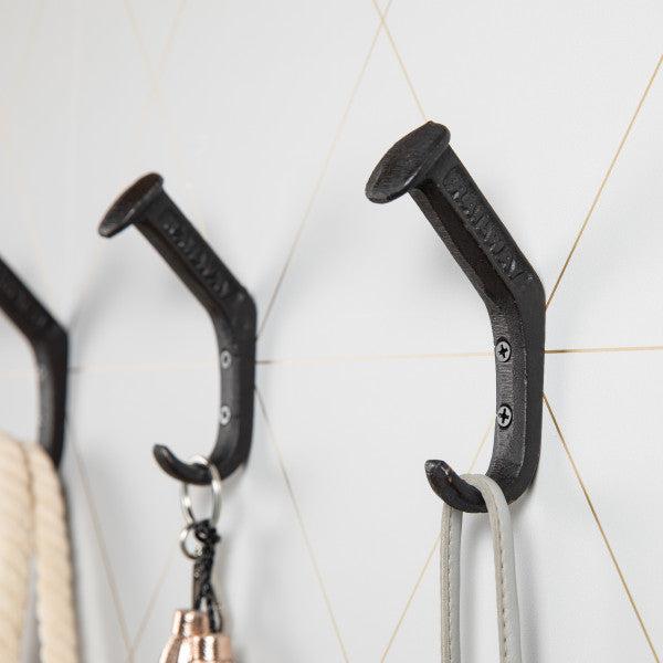 Danya B Black Cast Iron Railway Spike Wall Mount Hook close up with 'railway' visible.