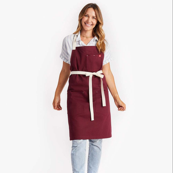 Young woman wearing Hedley & Bennett Bordeaux Crossback Apron