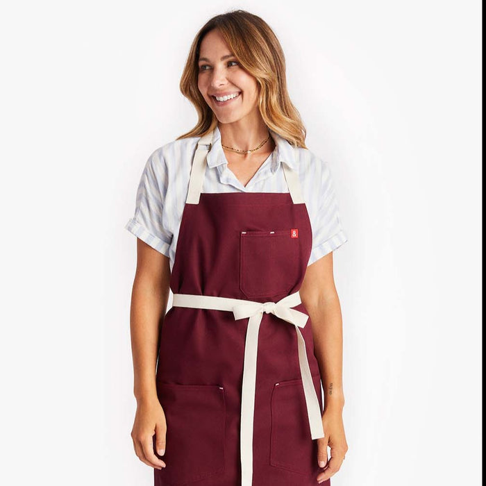 Young woman looking to the side wearing Bordeaux Crossback Apron