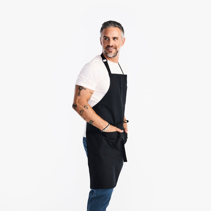 Man wearing apron with his hand in large front pocket
