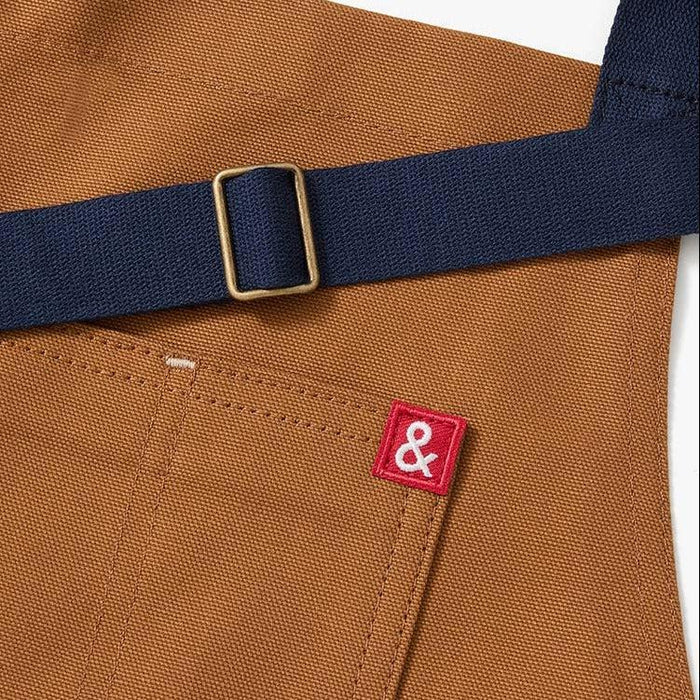 Sun-kissed golden brown apron with navy blue straps