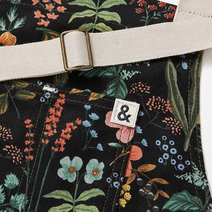 Flower print apron with white straps and Hedley & Bennett logo on front
