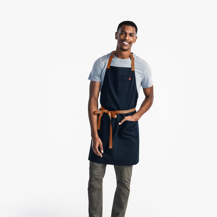 Man wearing Hedley & Bennett Midnight Essential Apron with his hand in large front pocket