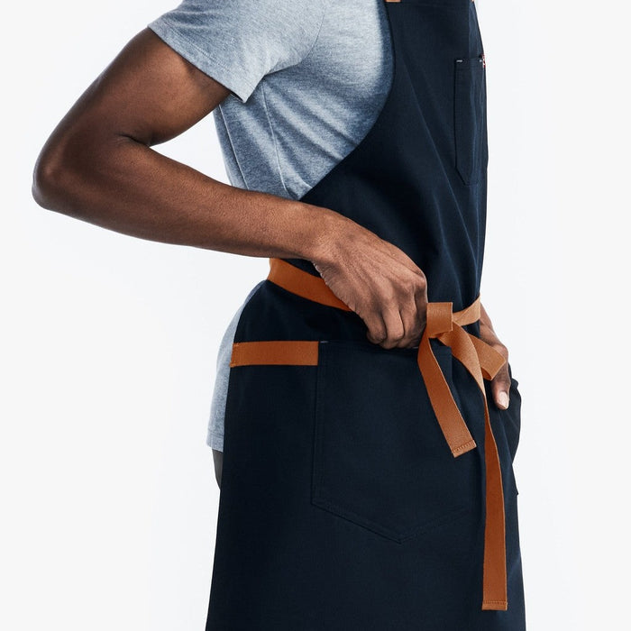 Man adjusting apron straps