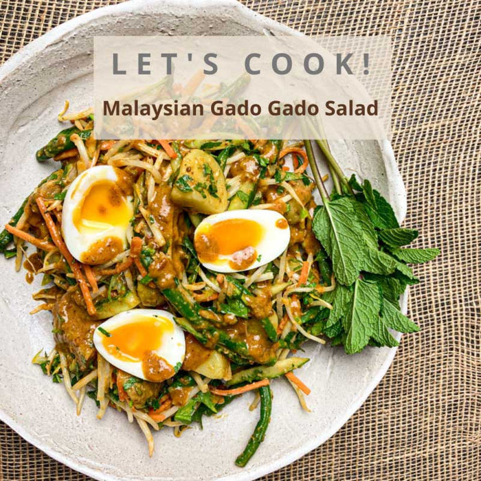 A picture of the recipe for Gado Gado Salad made with Jimmy's Sate Sauce showing a bowl with green beans, potato, carrots, cucumber and boiled eggs.