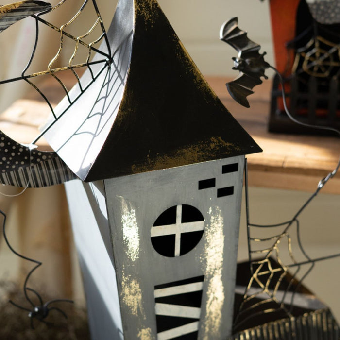 Close up blue halloween house decoration with bat and spiderwebs.