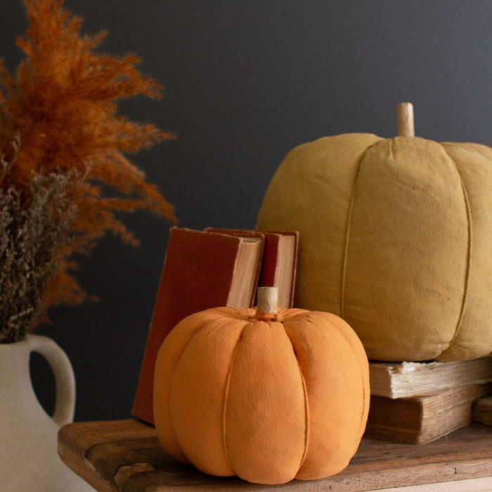 Orange and gold canvas pumpkin displayed with books.