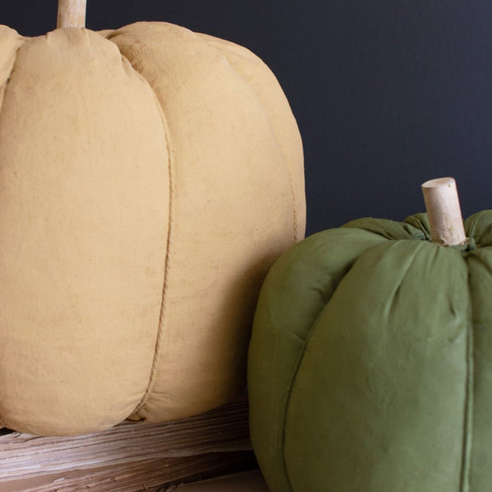 Green and gold canvas pumpkins close up.