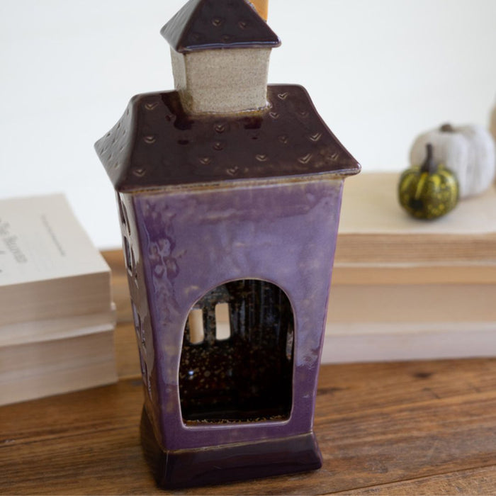 Ceramic building with opening for LED light.