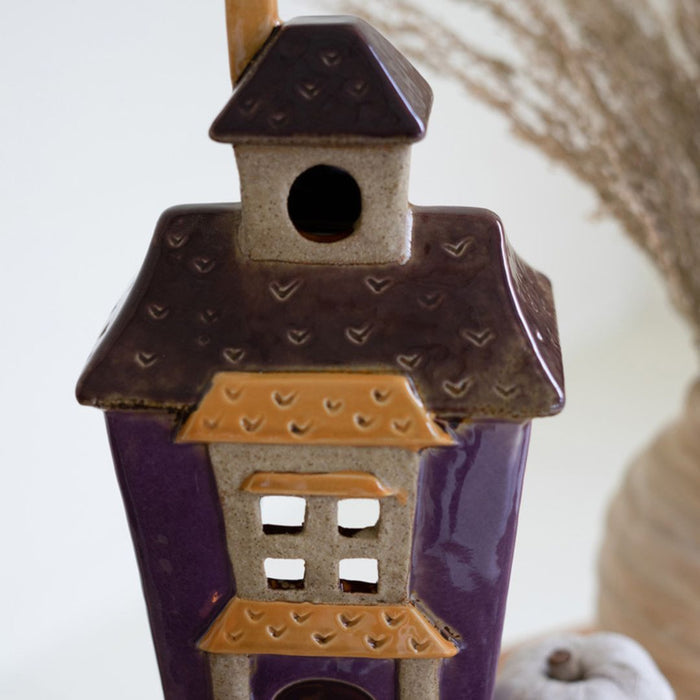 Close up of largest ceramic halloween building with bat roof detail.
