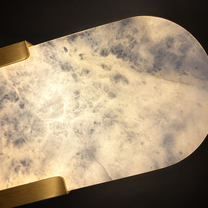 Extreme close up showing natural translucent cloud-like patterns of illuminated Spanish alabaster stone with brass bracket