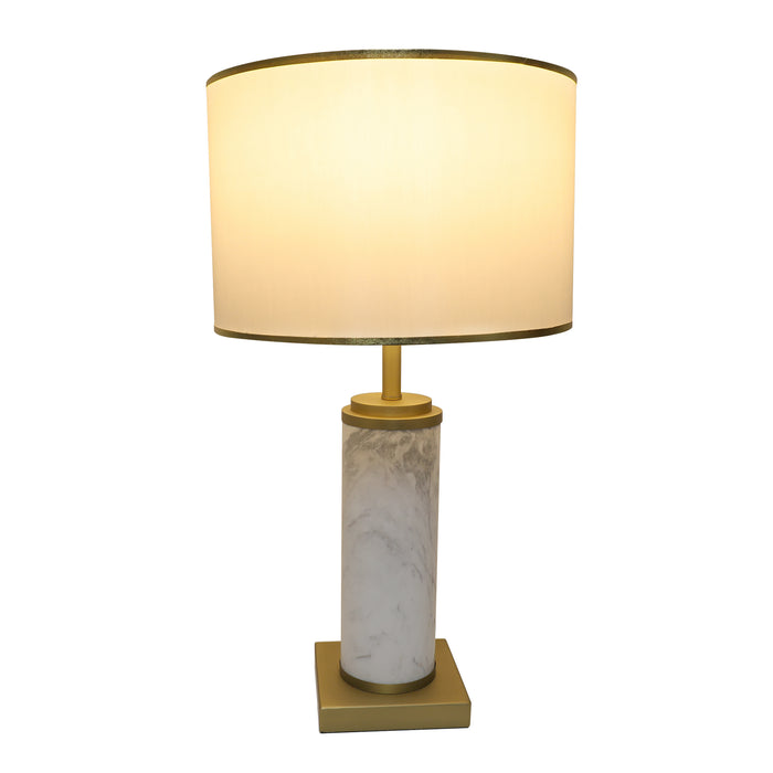 Illuminated white marble table lamp glowing warm ambient light under fabric shade on white background