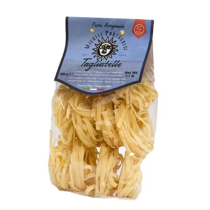A 500g pack of Pasta Michele Portoghese Dry Tagliatelle nests in a clear bag on a white background