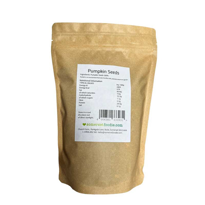 The reverse side of a Kraft paper style 500g bag of pumpkin seeds with a label on a white background