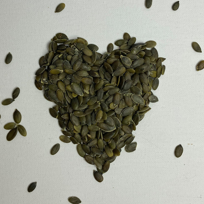 Pumpkin seeds arranged in the shape of a heart