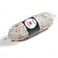 A mini Salcis Salami Toscana with a small black paper sleave on a white background