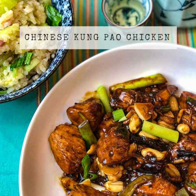 Recipe for Chinese Kung Pao Chicken - chunks of chicken in a soy and peanut sauce with spring onions in a white bowl.