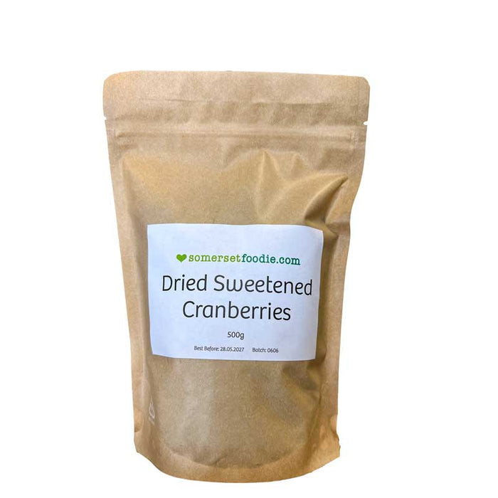 A Somerset Foodie 500g brown Kraft style pouch of dried sweetened cranberries with a label on a white background