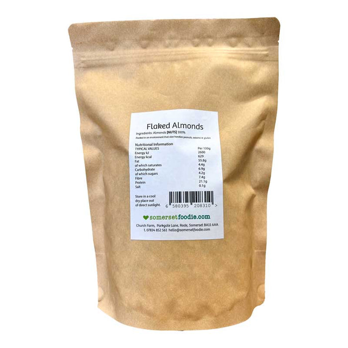 The reverse side of a Somerset Foodie 500g Kraft bag of flaked almonds with a label on a white background