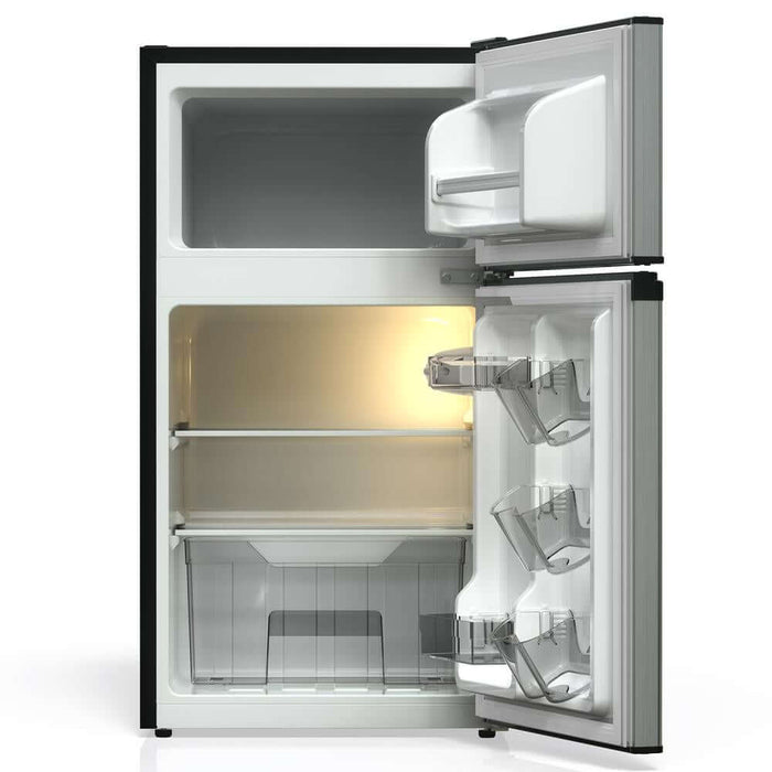 Open TCL 18 in. 3.1 Cu. Ft. Compact Top Freezer Mini Fridge in Silver (TRM31D4AV) with interior lights on a white background