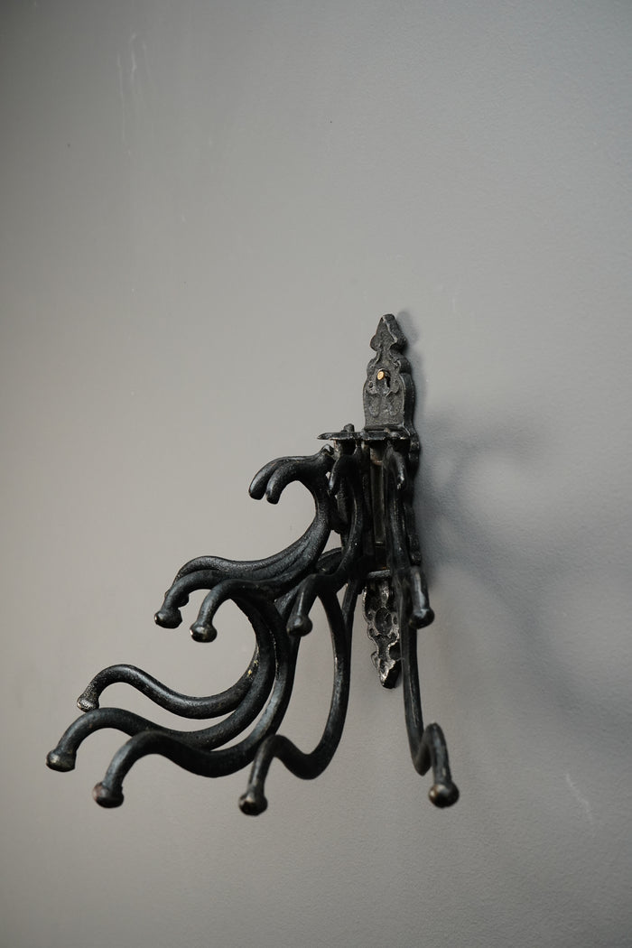 Decorative metal hook on a gray background