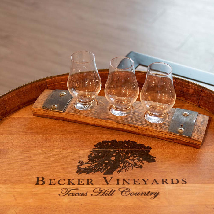 Whiskey and Wine Design Glassware on wine barrel table.